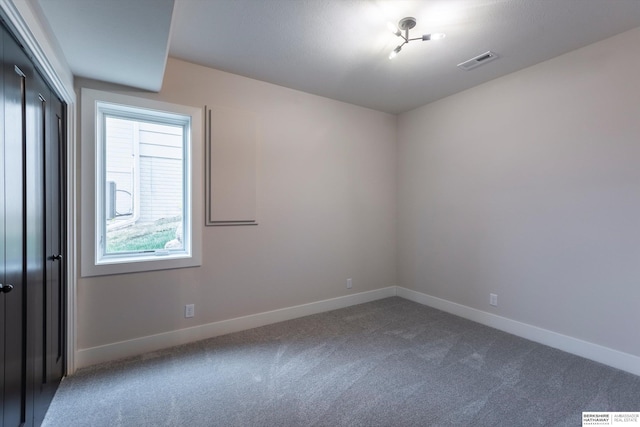 spare room featuring carpet floors