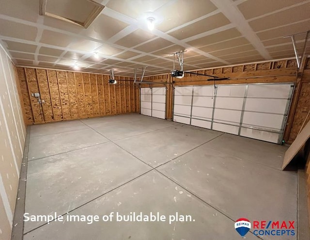 garage featuring a garage door opener and wooden walls