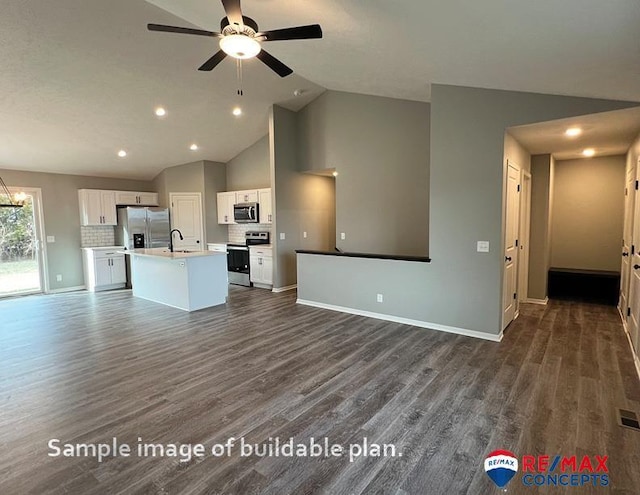 kitchen featuring appliances with stainless steel finishes, white cabinetry, an island with sink, and tasteful backsplash