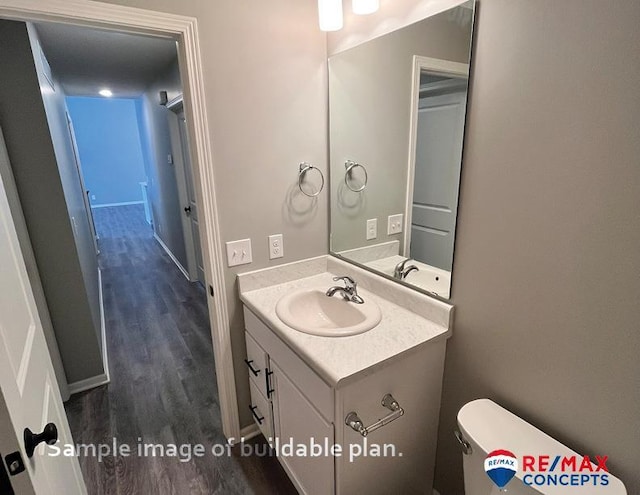 bathroom featuring vanity, hardwood / wood-style flooring, and toilet