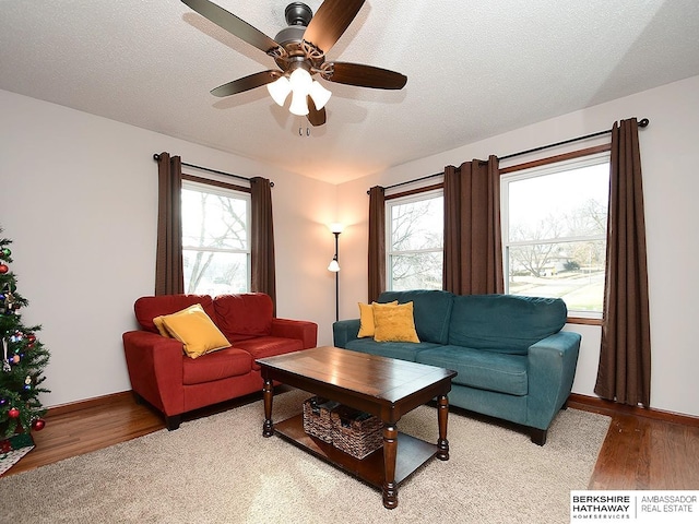 living room with ceiling fan, a healthy amount of sunlight, and a textured ceiling