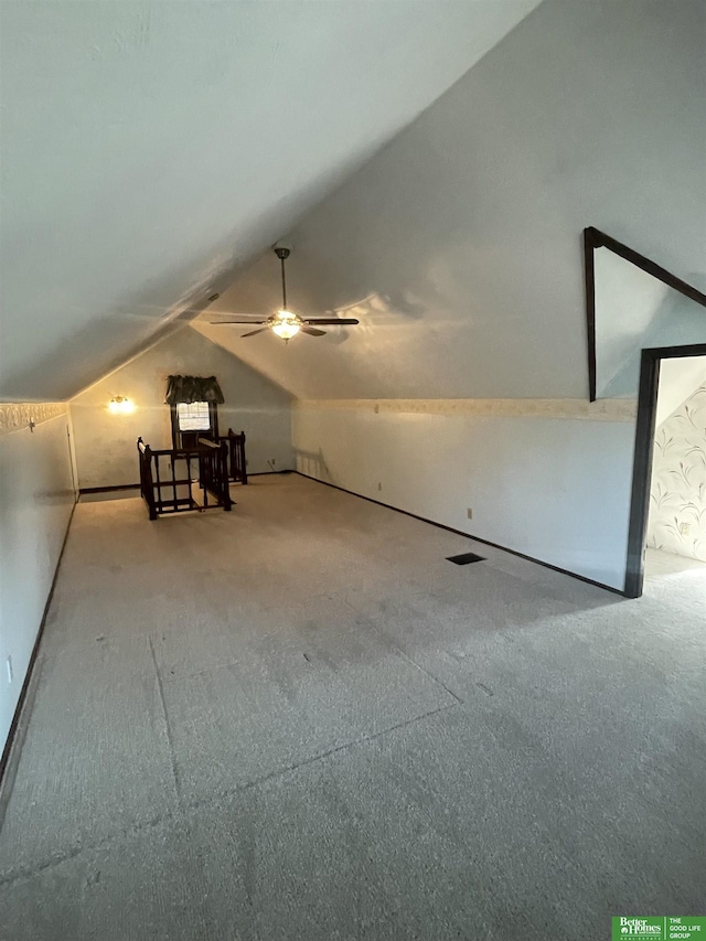 bonus room featuring ceiling fan, carpet flooring, and lofted ceiling