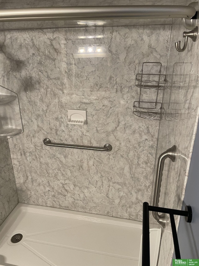 bathroom with tiled shower