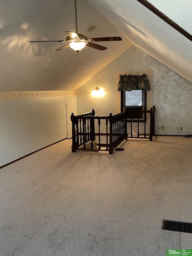 bonus room featuring ceiling fan, carpet flooring, and lofted ceiling