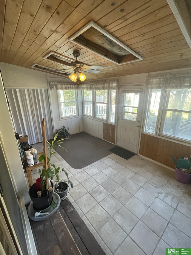 unfurnished sunroom with ceiling fan and wood ceiling