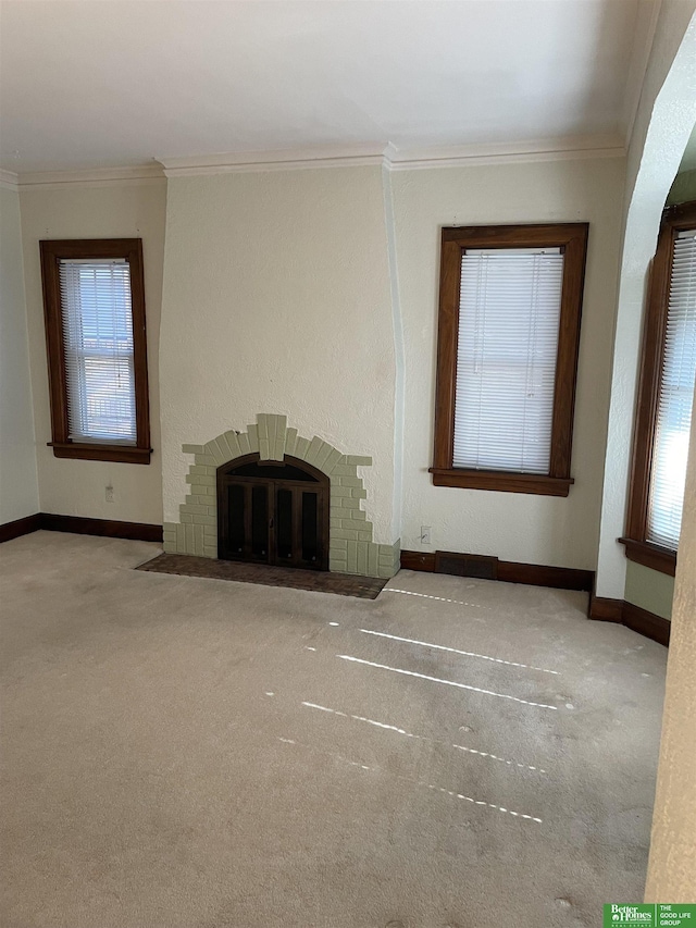 unfurnished living room featuring a fireplace, plenty of natural light, and crown molding