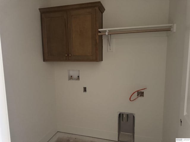 laundry area featuring hookup for a washing machine, cabinet space, baseboards, and electric dryer hookup