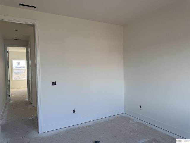 unfurnished room featuring baseboards