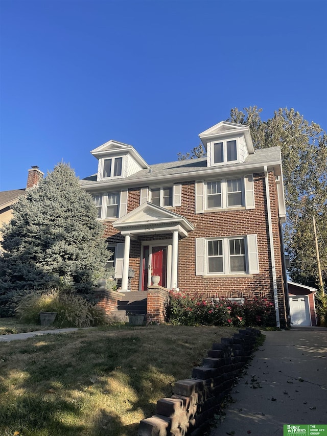 view of front of property with a garage and an outdoor structure