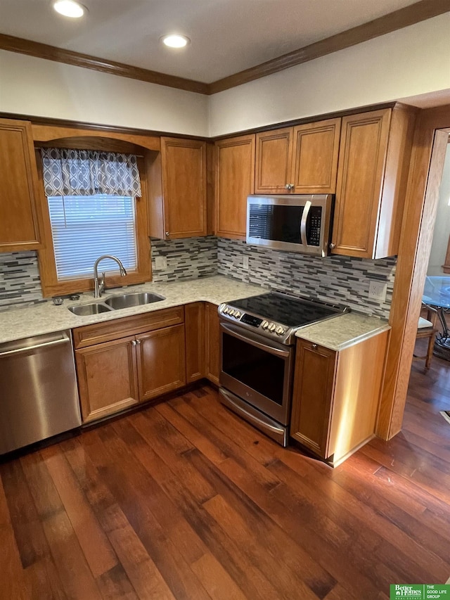 kitchen featuring dark wood-type flooring, crown molding, sink, tasteful backsplash, and stainless steel appliances