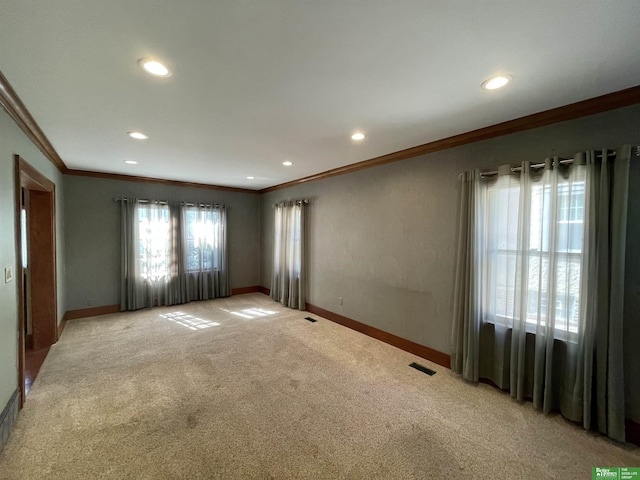 unfurnished room featuring light carpet and crown molding