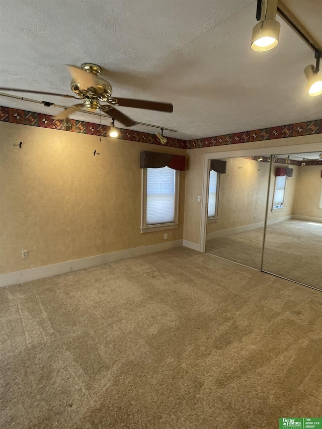 unfurnished bedroom with carpet flooring and a textured ceiling