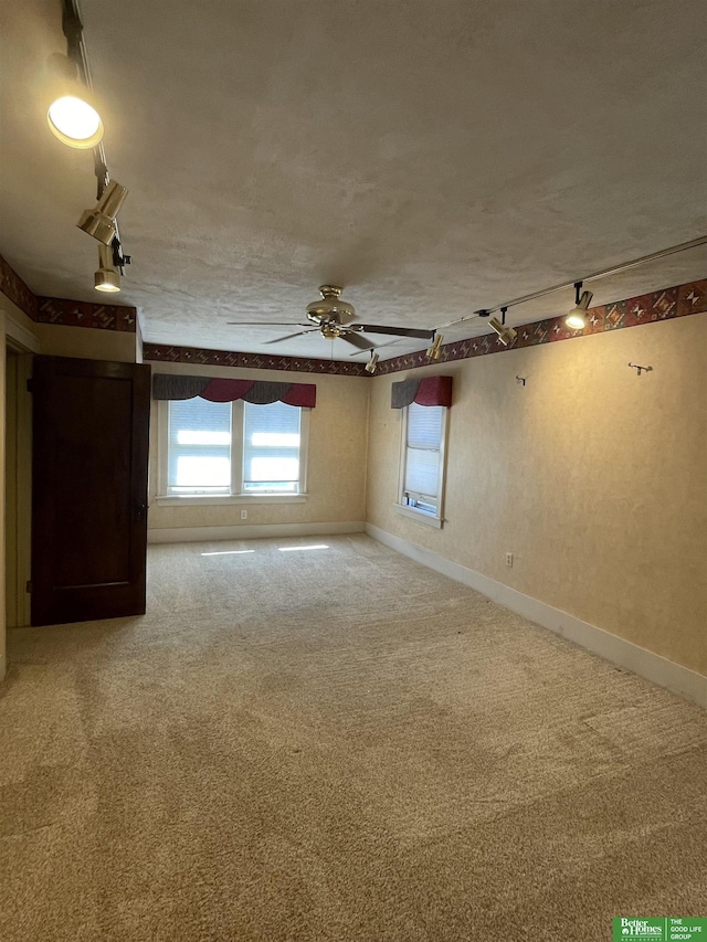 empty room featuring carpet flooring, ceiling fan, and a textured ceiling