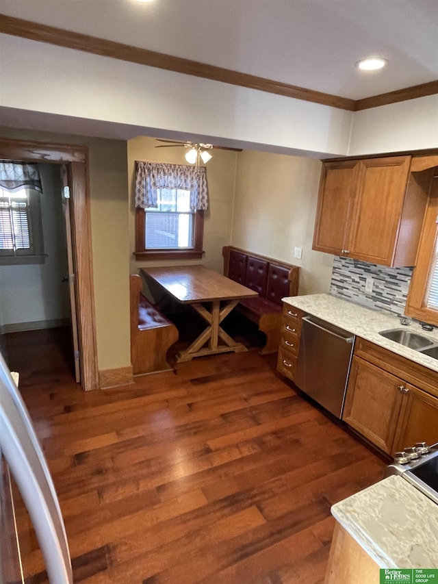 kitchen with ceiling fan, tasteful backsplash, stainless steel dishwasher, dark hardwood / wood-style floors, and crown molding