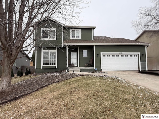 traditional-style house featuring a garage, covered porch, and concrete driveway