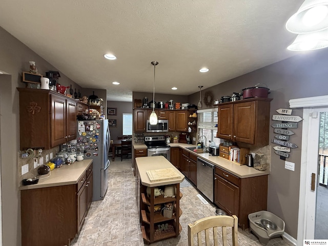 kitchen featuring a sink, open shelves, appliances with stainless steel finishes, and light countertops