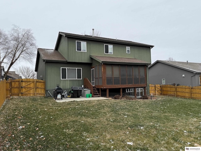 rear view of house with a lawn, a patio area, a fenced backyard, and a sunroom