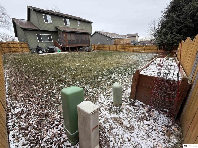 view of yard with a sunroom and a fenced backyard