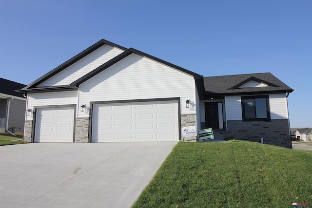 view of front of property with a front yard and a garage