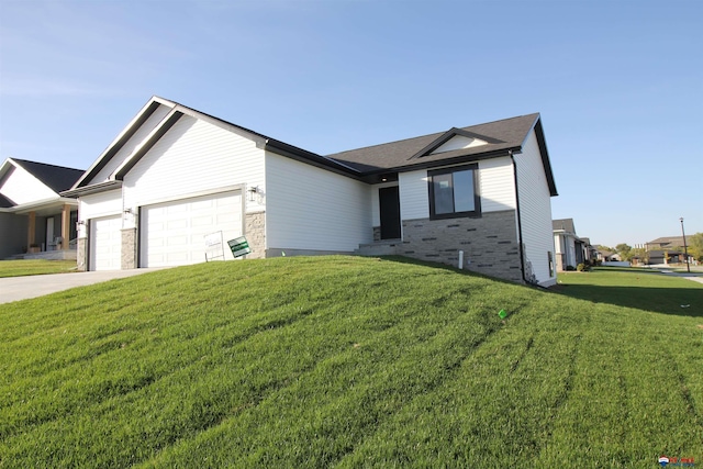 view of front of property with a front yard and a garage