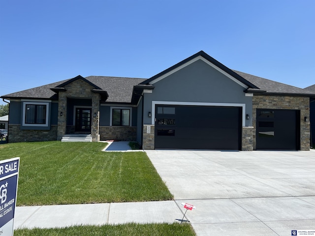 view of front of property with a garage and a front lawn