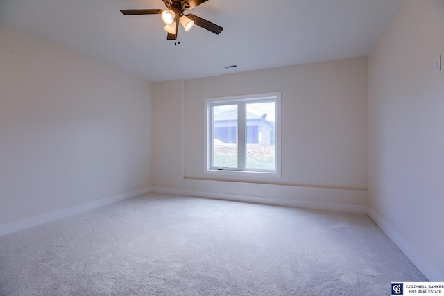 carpeted spare room with ceiling fan