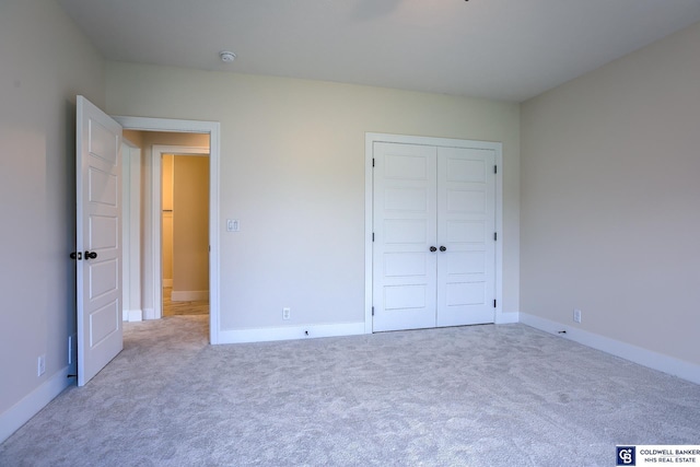 unfurnished bedroom featuring carpet flooring and a closet