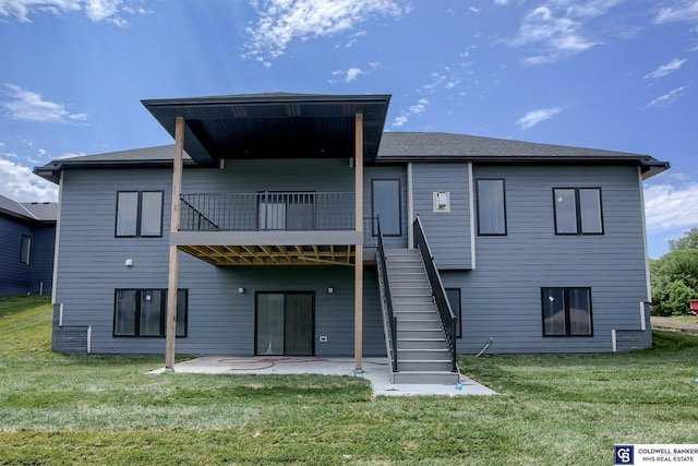 rear view of house with a patio area and a lawn