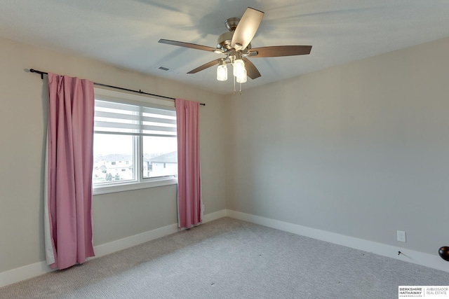 carpeted spare room with ceiling fan