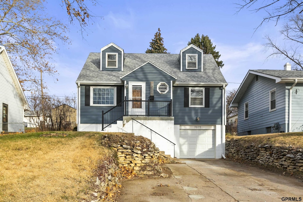 new england style home featuring a garage