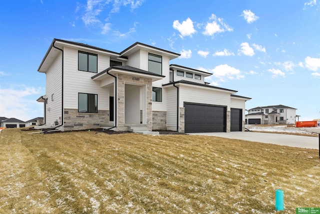 prairie-style house featuring a garage and a front yard