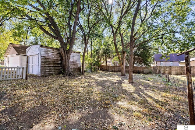 view of yard with a garage and an outdoor structure