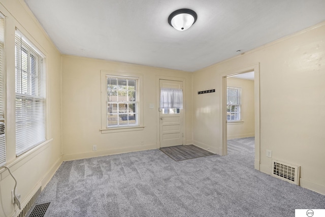 entryway with light colored carpet