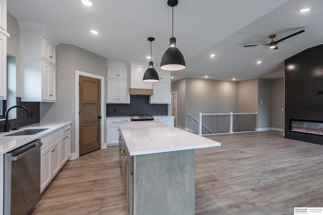 kitchen featuring a center island, sink, white cabinets, and appliances with stainless steel finishes