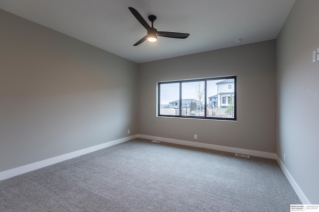 carpeted spare room featuring ceiling fan