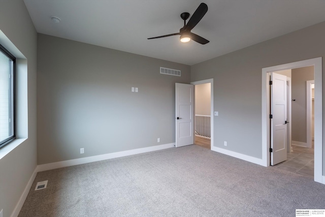 unfurnished bedroom featuring ceiling fan and light colored carpet