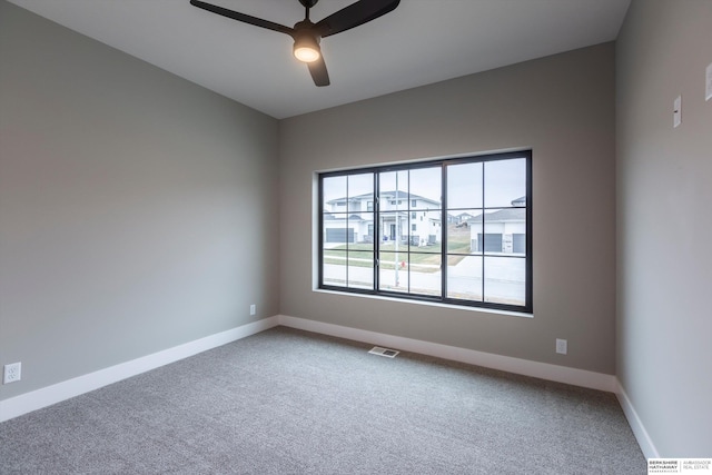 spare room with carpet flooring and ceiling fan