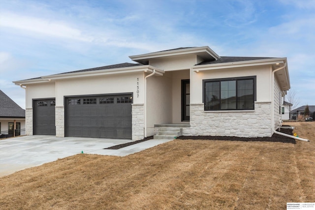 prairie-style house featuring a front lawn and a garage