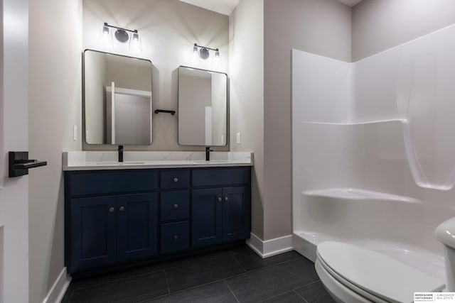 bathroom with tile patterned flooring, vanity, and toilet