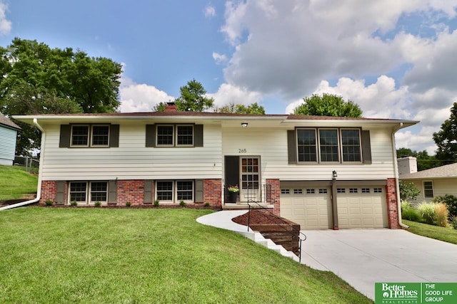 raised ranch featuring a garage and a front yard