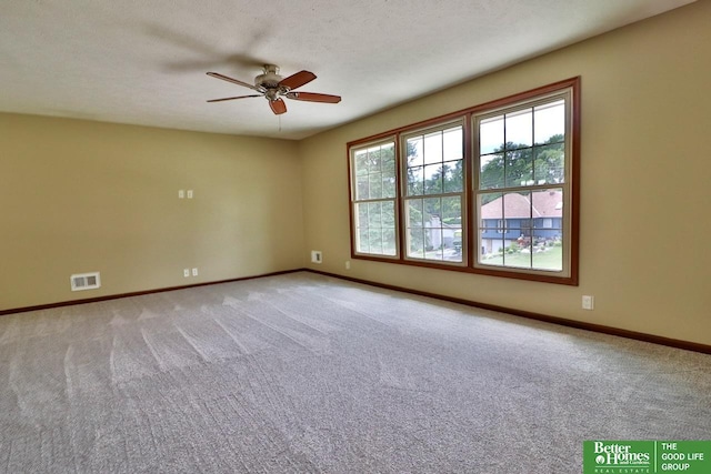 spare room featuring light colored carpet and ceiling fan