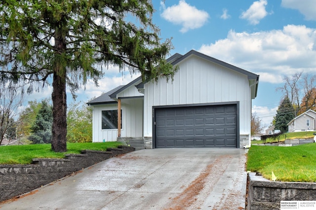 view of front of house with a garage and a front lawn