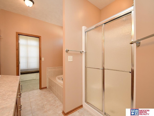 bathroom with vanity and independent shower and bath