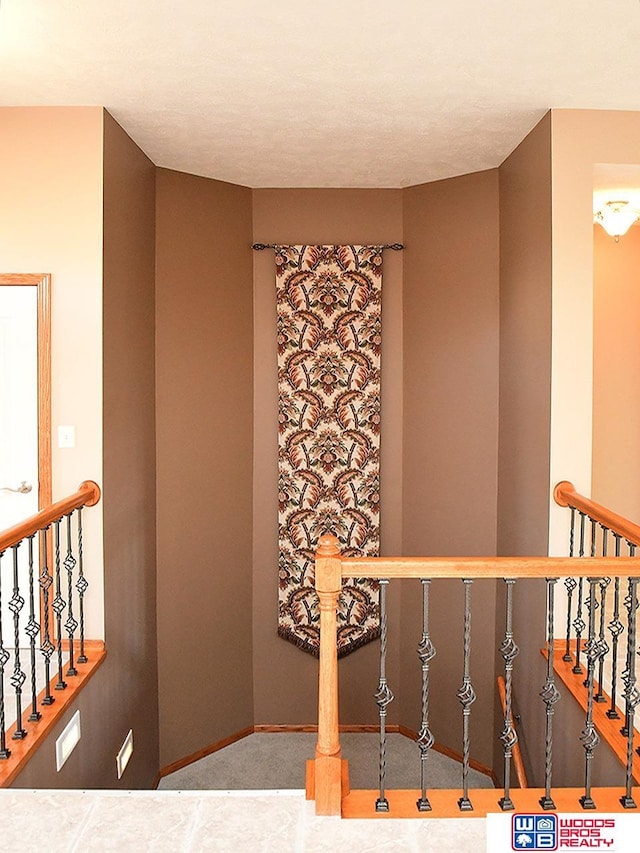 stairs featuring carpet flooring