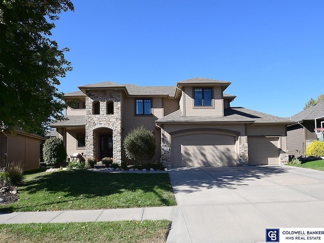 prairie-style house with a front yard and a garage