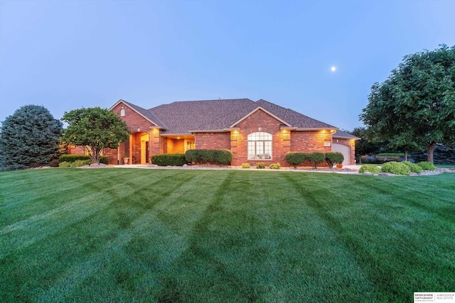 view of front of house with a garage and a lawn