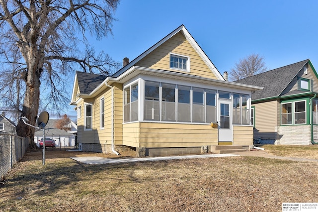 bungalow-style house featuring a sunroom