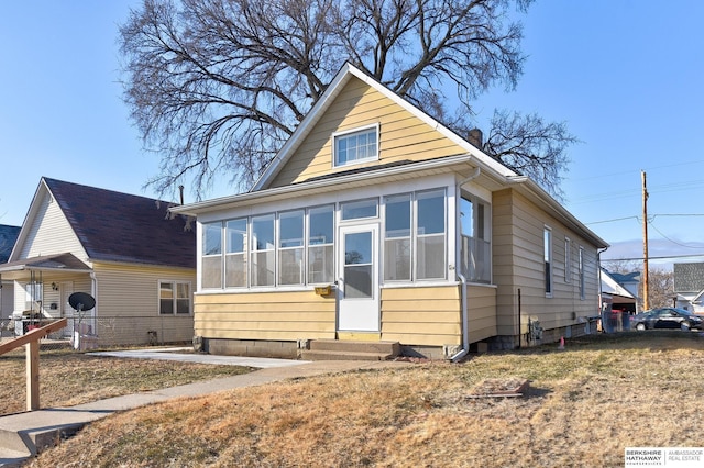 bungalow-style house with a sunroom