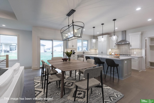 dining room with baseboards, a notable chandelier, wood finished floors, and recessed lighting