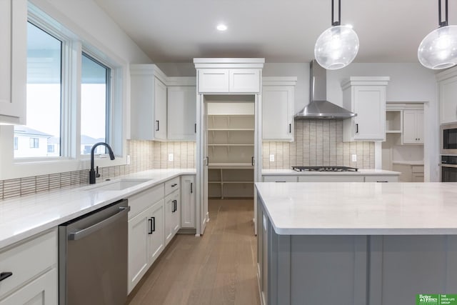 kitchen with open shelves, stainless steel appliances, white cabinets, a sink, and wall chimney range hood